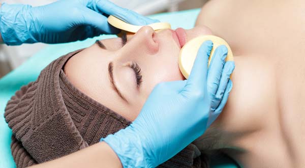 woman at a spa getting a deep cleaning facial