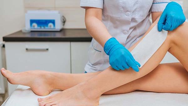 person having leg and body waxed