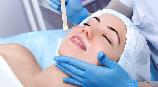 woman relaxing getting a face wax