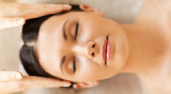 woman relaxing while she gets a facial